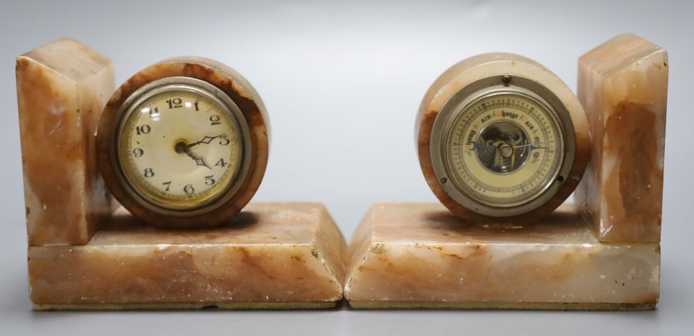 A pair of 1930s marble book-ends, one incorporates an aneroid barometer, the other a timepiece, 11cm